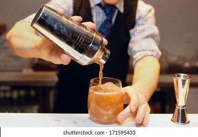 Bartender Is Making Cocktail At Bar Counter 