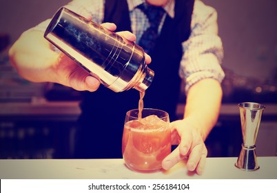 Bartender Is Making Cocktail At Bar Counter, Toned Image