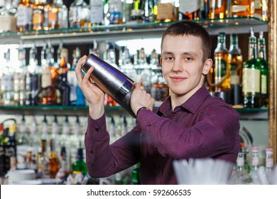 The bartender making cocktail in a nightclub bar - Shutterstock ID 592606535