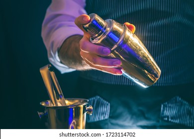 Bartender Making A Cocktail Using Cocktail Shaker; Barman Shaking Cocktail Ingredients In Cocktail Shaker