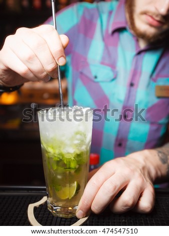 the bartender mixes a cocktail in a nightclub 2