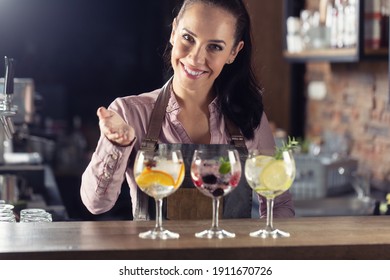 Bartender Offers Selection Of Various Gin Tonic Drinks Served On A Bar.