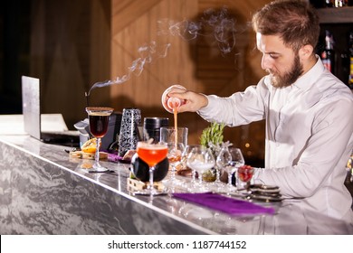 bartender pouring cocktail incredients. Lounge atmosphere