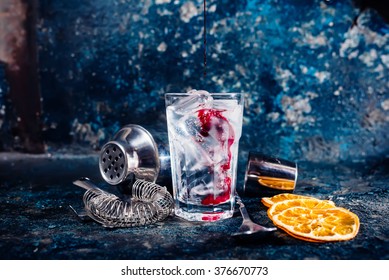 Bartender Pouring Cranberry Juice Over Vodka Cocktail