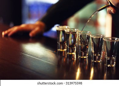 Bartender is pouring tequila into glass - Powered by Shutterstock