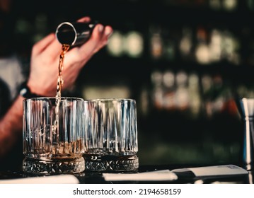 Bartender Pouring Whiskey On Glass In Bar