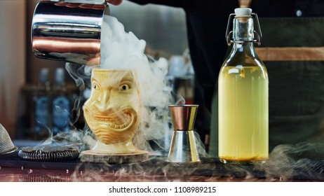 The bartender pours steam in a Tiki glass - Powered by Shutterstock