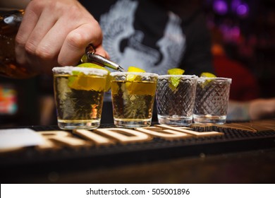 The Bartender Pours Tequila In The Bar Closeup