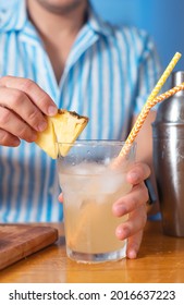 The Bartender Prepares A Cocktail At Home. Step Six: Decorate The Cocktail With A Pineapple Wedge And Ready To Enjoy