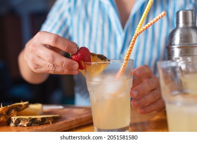 The Bartender Prepares A Cocktail At Home. Step Six: Decorate The Cocktail With A Strawberry Wedge