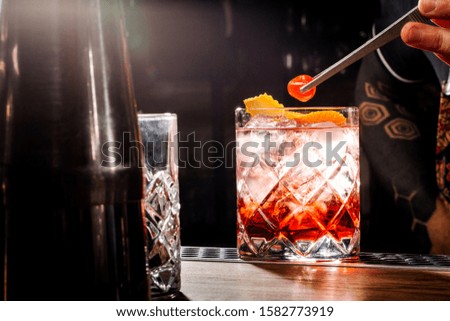 Bartender serves ready-made cocktail in the bar.  Man made a soft drink. 