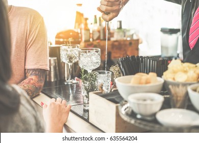 Bartender Serving Cocktail In American Bar Outdoor - Young Tattoo People Waiting For Drink At Sunset - Soft Focus On Hand Metal Pour - Lifestyle,nightlife And Entertainment Concept - Vintage Filter