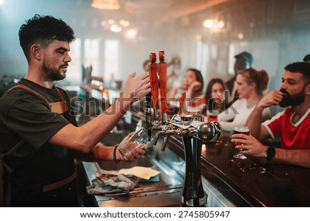 Bartender serving drinks at a beer tap on a smoky bar counter while diverse customers are enjoying social life in the background