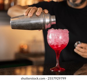 Bartender serving tequila sunrise alcoholic cocktail in glass on bar - Powered by Shutterstock