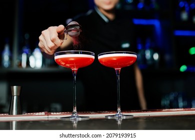 The Bartender Sprinkles The Cocktail With Red Powder.