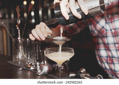 Bartender Is Straining Drink In A Glass, Toned, Misty, Bleached Colors