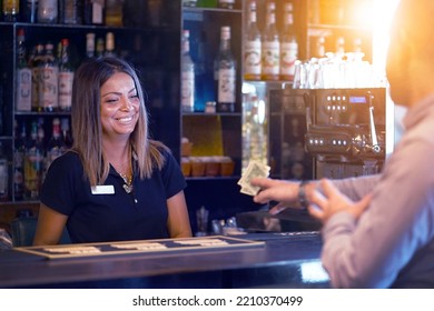 Bartender Takes The Tip Dollar. Bartender Girl Receives A Tip From The Client At The Hotel Bar. Bartender Woman Is Happy To Receive A Tip At Work. Concept Of Service