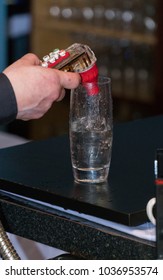 Bartender Uses Fountain Soda Gun To Pour Alcoholic Mixed Drink Into Tall Glass With Ice For Thirsty Customer.