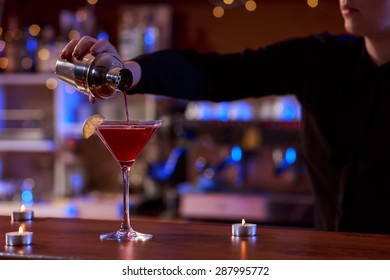 Bartender Is Using A Cocktail Shaker In The Bar