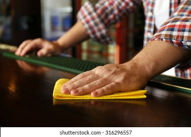 Bartender Wiping Down Bar Counter