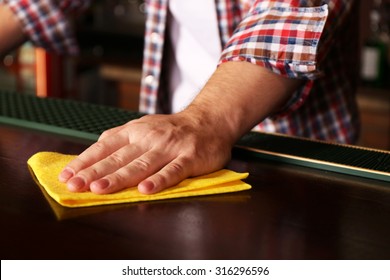 Bartender Wiping Down Bar Counter