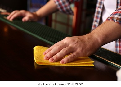 Bartender Wiping Down Bar Counter