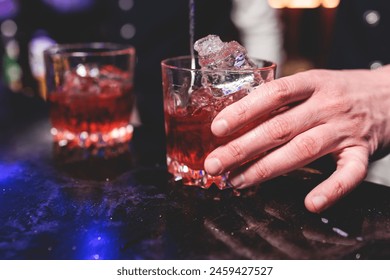 Bartender working, beautiful row line of different coloured liquor alcohol cocktails on a party in a bar, and others on catering banquet on event, barman mixing drinks and beverages in a club
 - Powered by Shutterstock