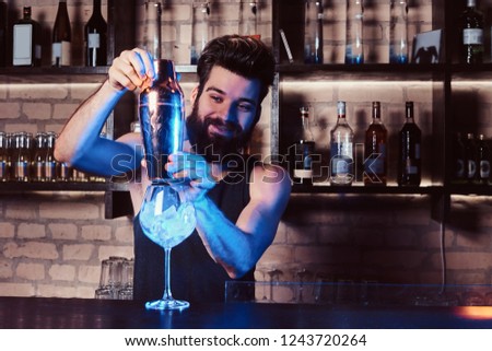 A bartender working behind the bar counter