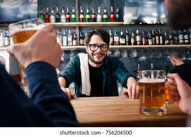 The Bartender Is Working Behind The Bar, Handsome Bar Tender Standing Behind His Counter In A Pub