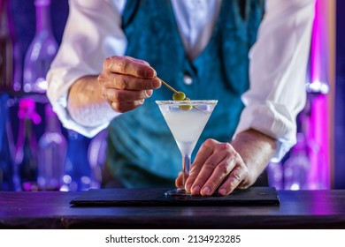 Bartender's Hands Serving Cocktails On Bar Counter In A Restaurant, Pub. Professional Mixologist Mixing Drinks. Alcoholic Cooler Beverage At Nightclub. Selected Focus, Shallow Depth Of Field.