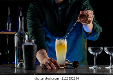 Bartender's Hands Shaking Cocktails On Bar Counter In A Restaurant, Pub. Professional Mixologist Mixing Drinks. Alcoholic Cooler Beverage At Nightclub. Selected Focus, Shallow Depth Of Field.