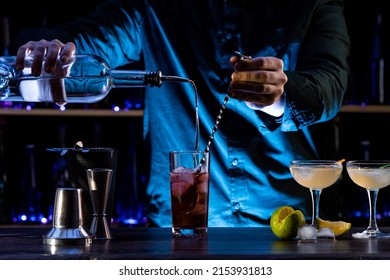 Bartender's Hands Shaking Cocktails On Bar Counter In A Restaurant, Pub. Professional Mixologist Mixing Drinks. Alcoholic Cooler Beverage At Nightclub. Selected Focus, Shallow Depth Of Field.