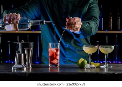 Bartender's Hands Shaking Cocktails On Bar Counter In A Restaurant, Pub. Professional Mixologist Mixing Drinks. Alcoholic Cooler Beverage At Nightclub. Selected Focus, Shallow Depth Of Field.