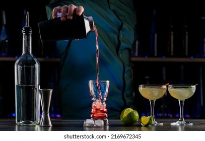 Bartender's Hands Shaking Cocktails On Bar Counter In A Restaurant, Pub. Professional Mixologist Mixing Drinks. Alcoholic Cooler Beverage At Nightclub. Selected Focus, Shallow Depth Of Field.