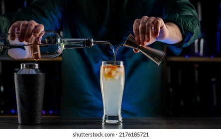 Bartender's Hands Shaking Cocktails On Bar Counter In A Restaurant, Pub. Professional Mixologist Mixing Drinks. Alcoholic Cooler Beverage At Nightclub. Selected Focus, Shallow Depth Of Field.