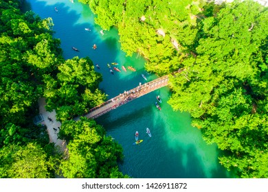 Barton Creek Bridge Spanning Across The Cold Spring Fresh Clear Waters Of Barton Creek In Austin Texas Skyline Cityscape Aerial Drone View Above Green Landscape Barton Creek Flowing Into Town Lake