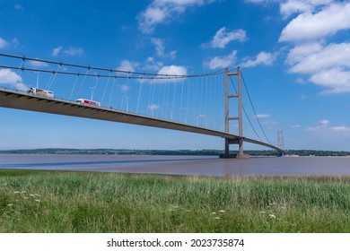 Barton, Linconshire, UK, 16 June 2021 - Lorries crossing the Humber Bridge on a clear sunny day with blue sky.