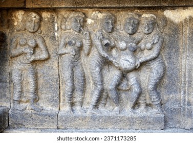 Bas relief of Pregnant Woman giving child birth with Labor Women's. Relief sculpture carved in stone wall at Airavatesvara Temple in Darasuram, Kumbakonam, Tamilnadu.
