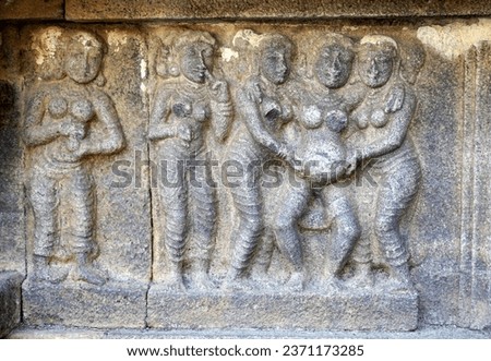 Bas relief of Pregnant Woman giving child birth with Labor Women's. Relief sculpture carved in stone wall at Airavatesvara Temple in Darasuram, Kumbakonam, Tamilnadu.