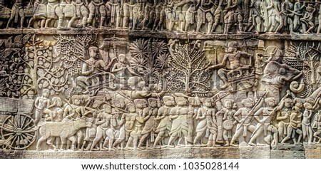 Bas relief sculpture, elephant charging into battle and the battle between the Cham and Khmer. The battles conducted by Jayavarman VII against the invading Cham. Bayon Temple, Angkor Thom, Seam Reap.