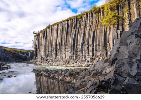 Basalt columns coloured orange by iron oxide, Studlagil Canyon, Egilsstadir, Austurland, Iceland