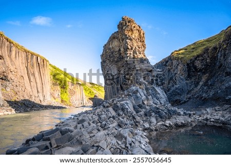 Basalt columns coloured orange by iron oxide, Studlagil Canyon, Egilsstadir, Austurland, Iceland