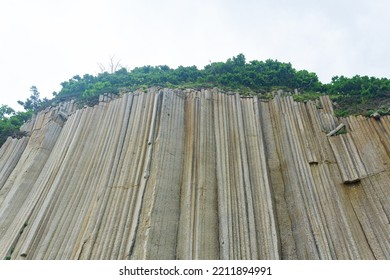 basalt columns forming a coastal rock at Cape Stolbchaty on Kunashir Island - Shutterstock ID 2211894991