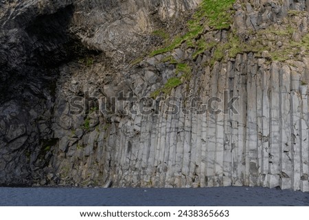 Basalt hexagonal columns rock formations in Halsanefshellir cave on Reynisfjara Black Sand Beach, Iceland.