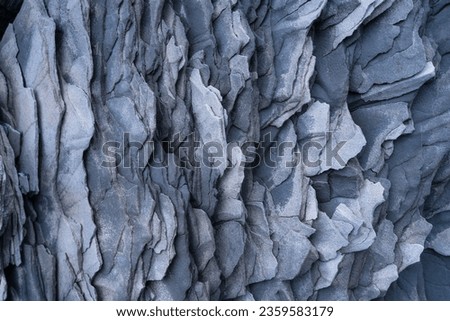 Basalt stones as a background. Image for background and wallpaper. Sharp rocks. Photography for design. Textures in nature.