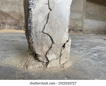 The base of the concrete pillar has cracks and loose cement.
