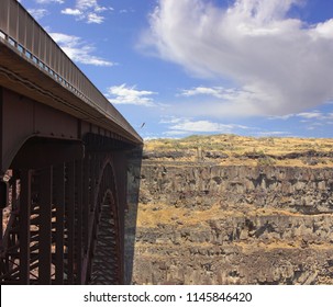 Base Jumper Jumping Off Bridge Into Canyon