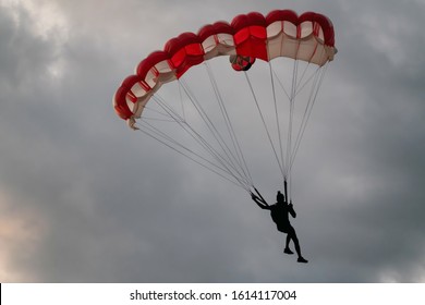 Base Jumping In Thailand. The Parachute And The Silhouette Of The Base Jumper Against The Sunset Sky. Tonsai Beach, Krabi Province, Thailand.