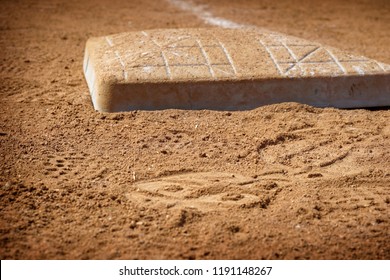 Base On The Dirt Infield Of Baseball Field                               