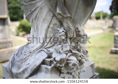 Base of a Stone Monument Woman's Feet with Flowers Statue